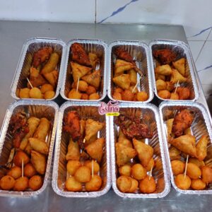 Delight your guests with our Deluxe Small Chops Tray, the ultimate party platter for any occasion. This carefully curated tray includes: 30 crispy samosas bursting with flavorful fillings. 30 golden spring rolls with a delectable crunch. 80 tender, juicy small beef bites that are perfectly seasoned. 60 delicious mosa, a fried delicacy with a soft, sweet core. 100 fluffy puff puffs, lightly sweetened and fried to perfection. Ideal for birthdays, weddings, or casual get-togethers, this tray guarantees a mouthwatering experience for 10-15 guests. Make your celebrations unforgettable with this irresistible mix of Nigerian small chops!